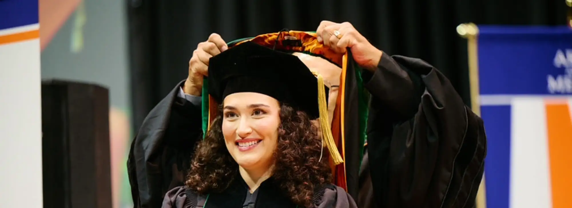 student being hooded at commencement